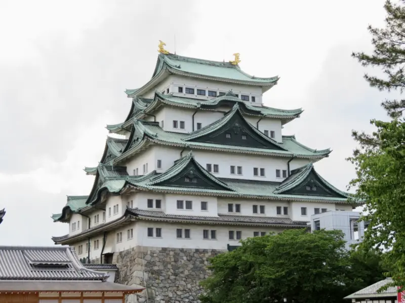 Majestic view of Nagoya Castle surrounded by greenery
