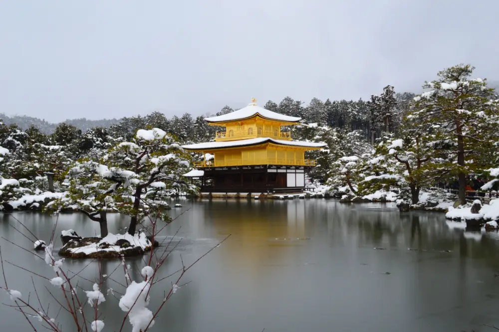 Kinkakuji covered in snow, showcasing its serene winter beauty
