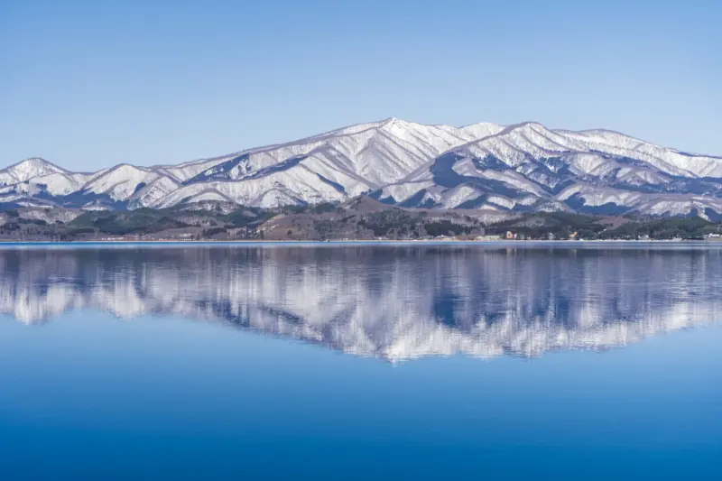 Lake Tazawa with crystal-clear blue waters surrounded by lush greenery