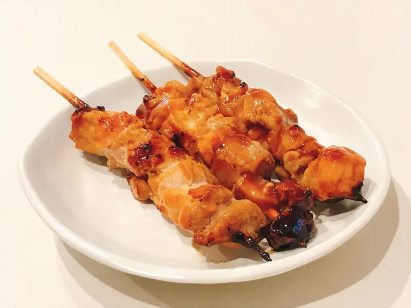 Juicy chicken thigh skewers served on a ceramic plate