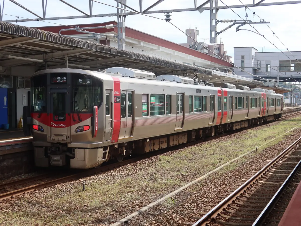 A JR train traveling from Hiroshima Station to Miyajimaguchi Station.