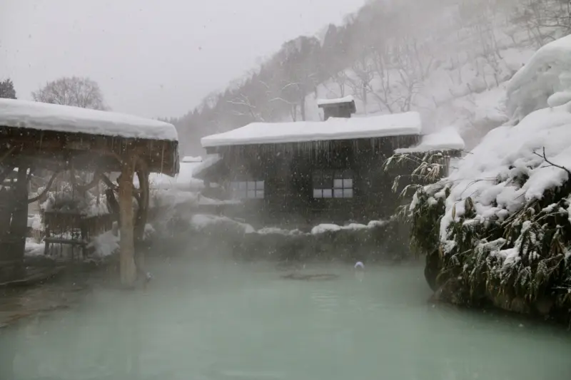 Outdoor hot spring baths surrounded by snow in Nyuto Onsen Village