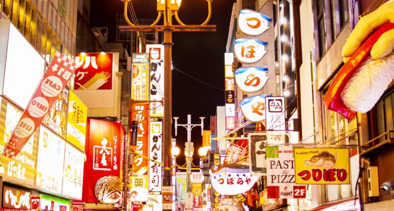 Dotonbori’s neon lights and reflections on the canal