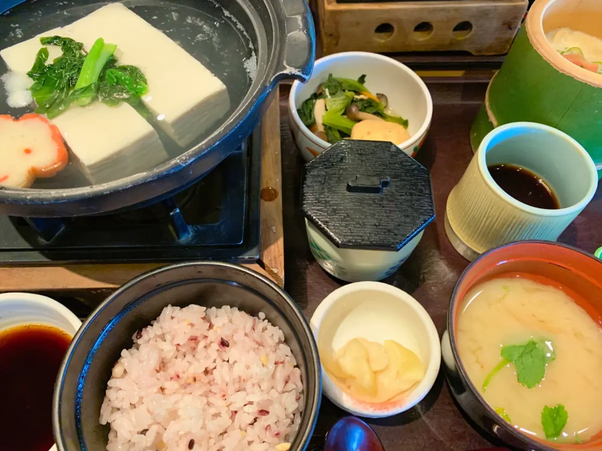 A traditional bowl of yudofu, a Kyoto specialty, served with dipping sauce.