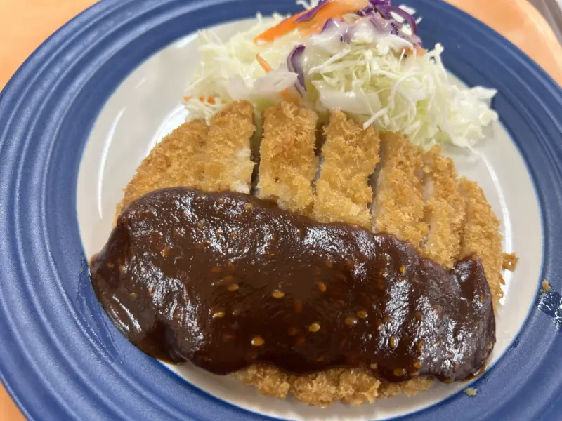 Crispy miso katsu served with rice and shredded cabbage
