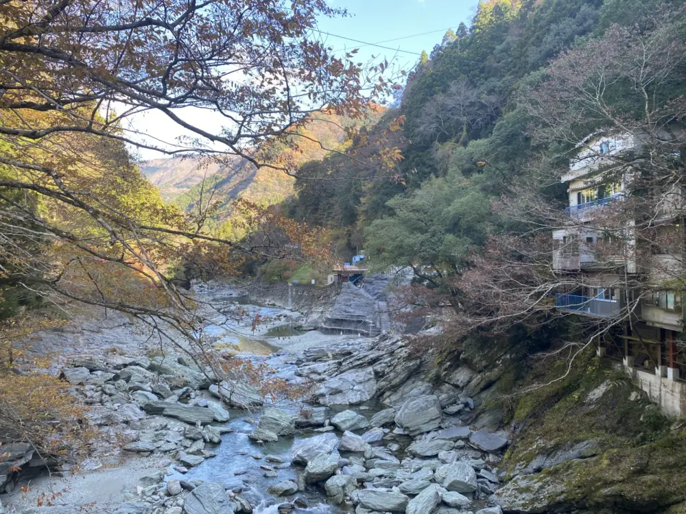 Open-air bath at Shin-Iya Onsen with panoramic mountain views.