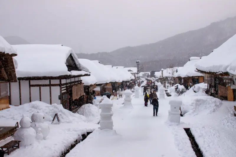 Ouchi-juku's traditional thatched-roof houses along a scenic street