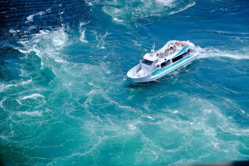  Sightseeing boat offering a close-up view of the Naruto Whirlpools during peak tidal flow.