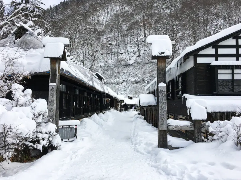 Outdoor hot spring baths surrounded by snow in Nyuto Onsen Village