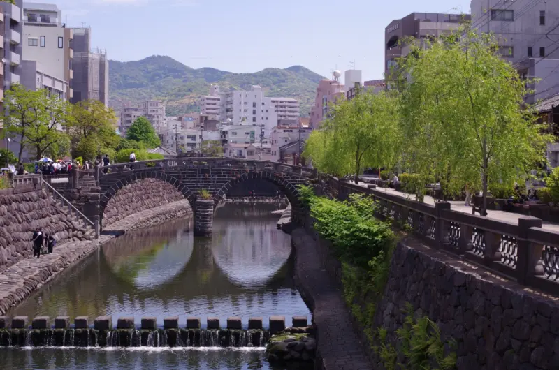 Megane Bridge with its distinctive twin arches reflected in the river