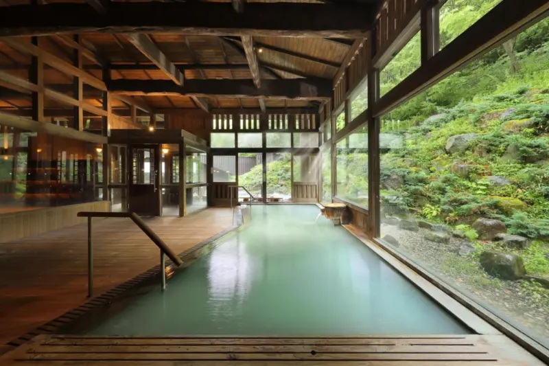 Zao Kokusai Hotel's serene outdoor hot spring bath with mountain views