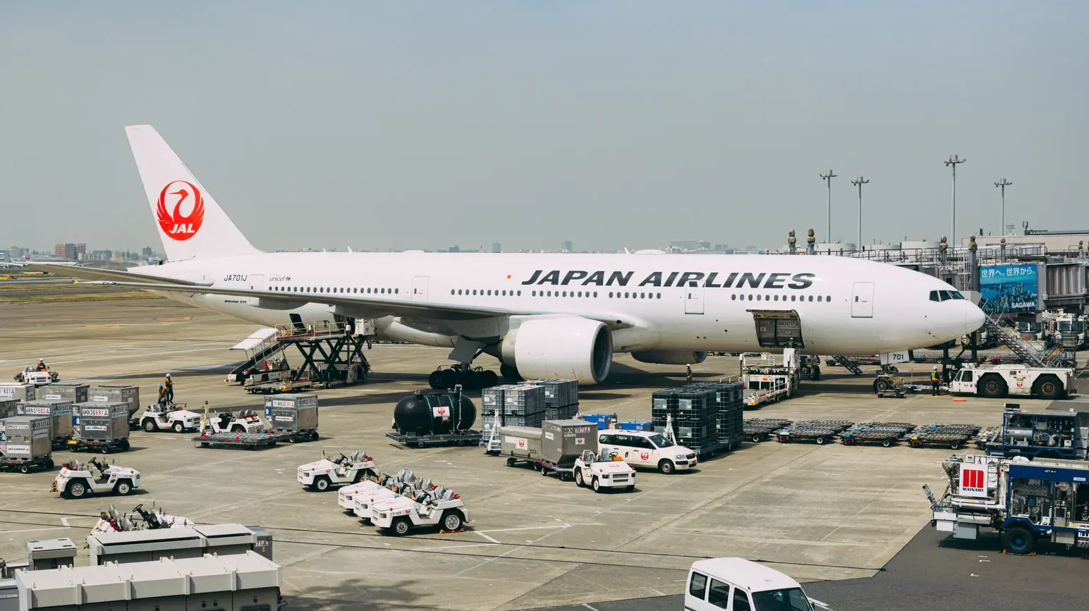 A Japan Airlines plane waiting at Haneda Airport, preparing for a Tokyo to Aomori flight.