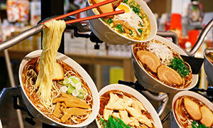 A replica of a ramen bowl displayed in front of a shop at the Shin-Yokohama Ramen Museum