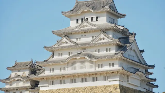 Himeji Castle UNESCO World Heritage Site with its iconic white walls under a clear blue sky