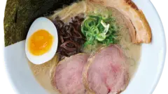 Ippudo ramen served in a white bowl, highlighting creamy broth and fresh ingredients