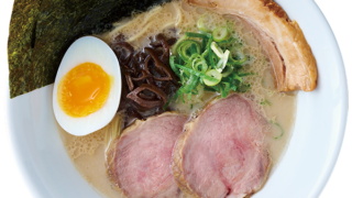 Ippudo ramen served in a white bowl, highlighting creamy broth and fresh ingredients