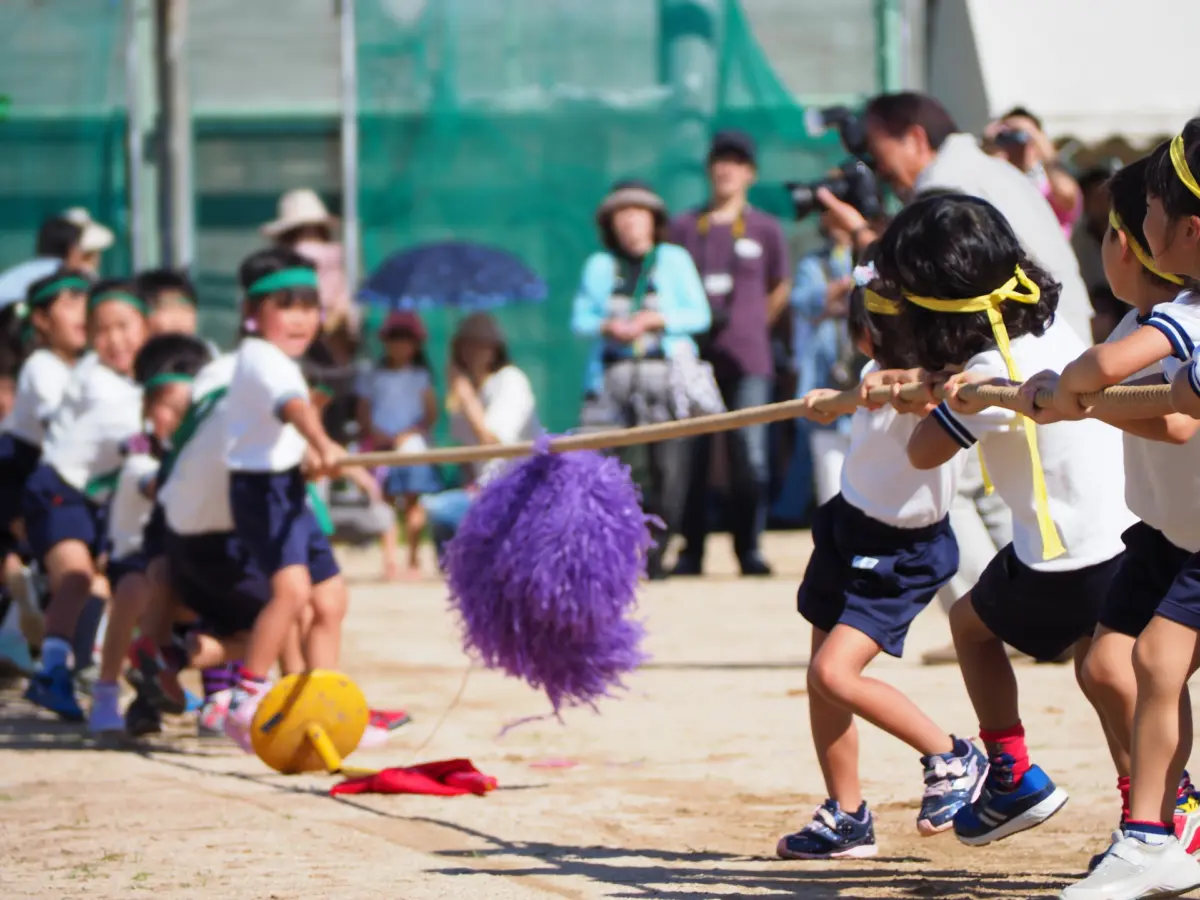 Children running in a school sports day event, celebrating Health and Sports Day in Japan, promoting fitness and teamwork.