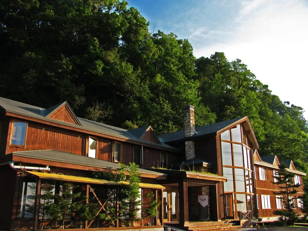 Kifuu Club Shiretoko, a cozy oceanfront hotel with warm wooden interiors and all rooms featuring views of the Okhotsk Sea.