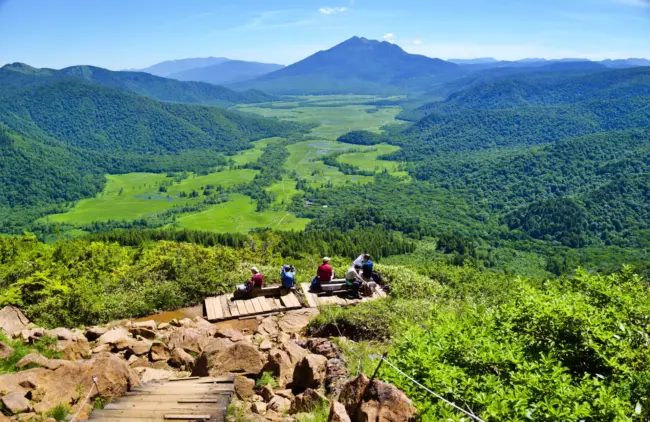 The tranquil wetlands of Oze National Park, surrounded by breathtaking mountain scenery.