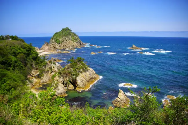 Crystal-clear waters and rugged rock formations along the Uradome Coast in Tottori