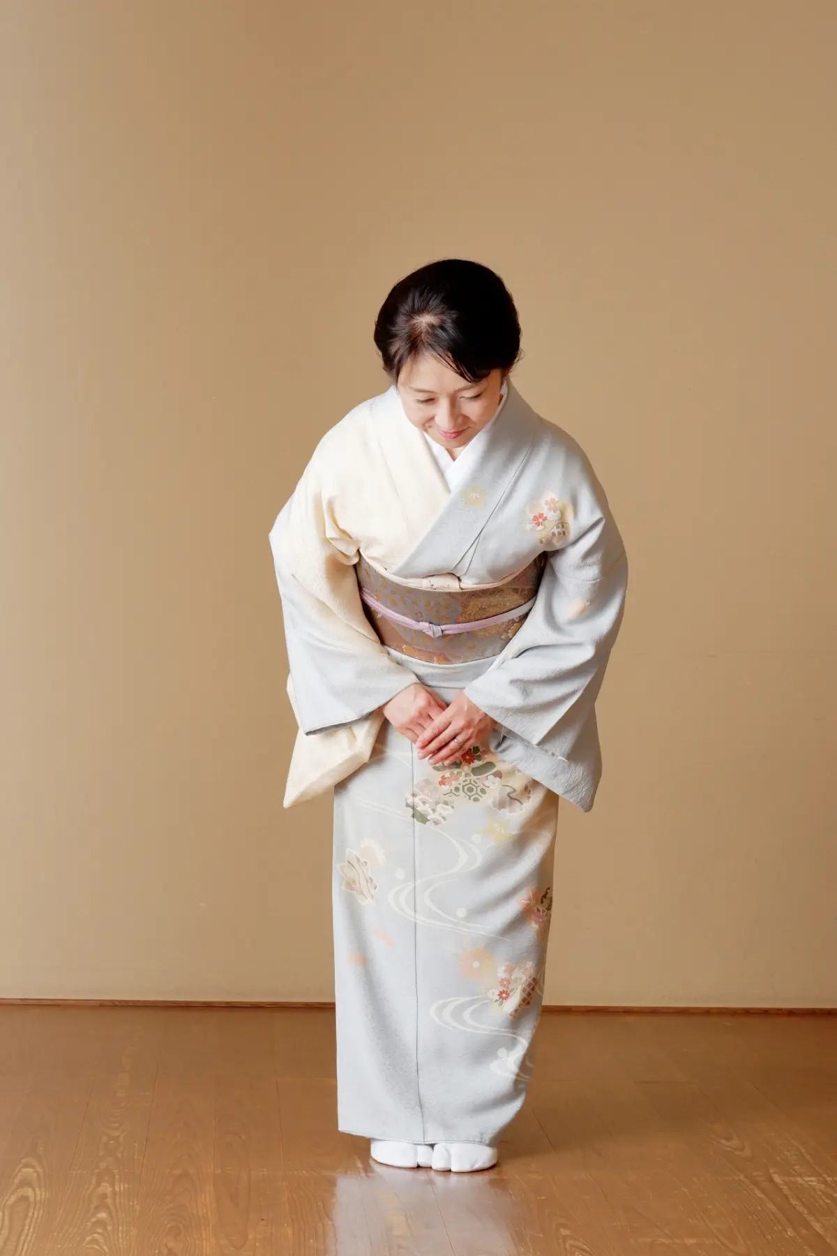 A woman with Traditional Japanese kimono bowing during a Japanese ceremony