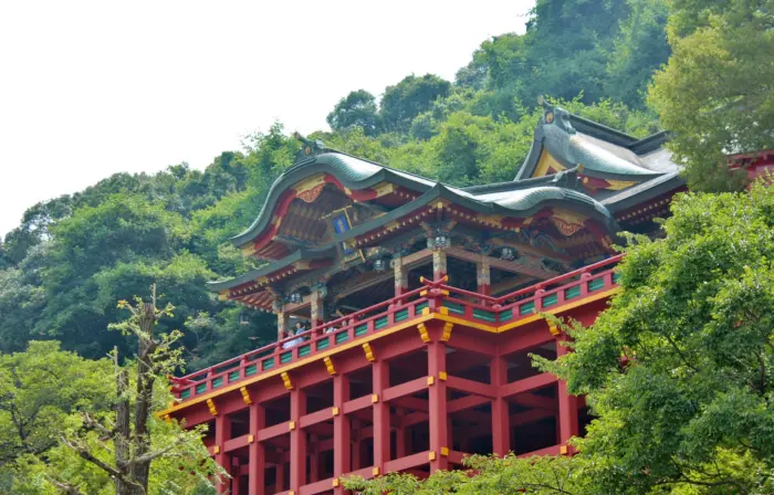 The vibrant red gates and lush greenery surrounding Yutoku Inari Shrine in Saga