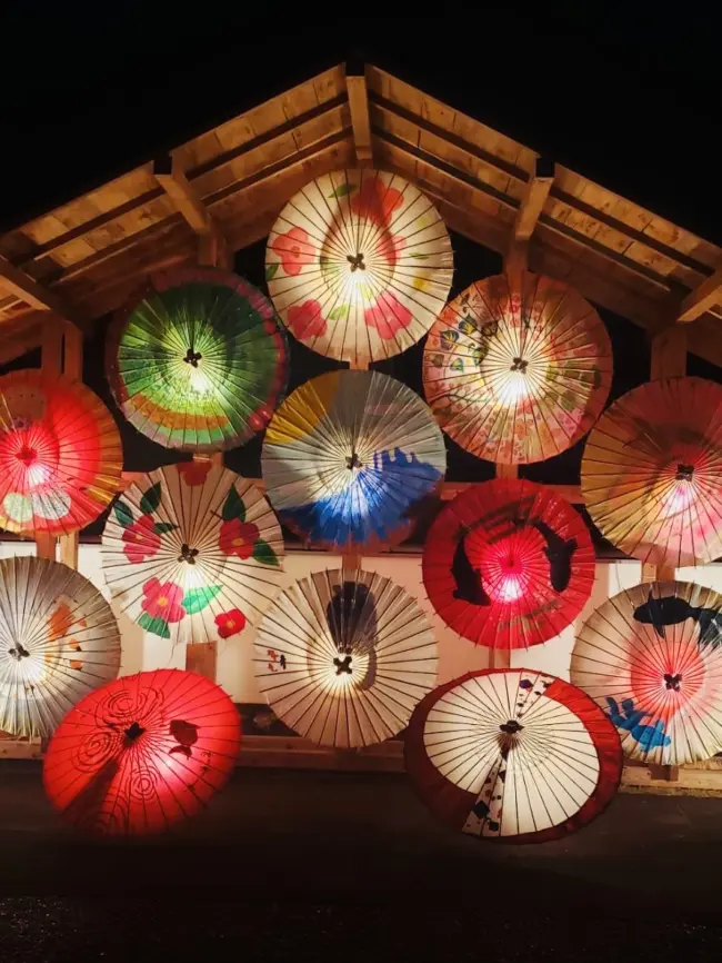 Women in yukata dancing with golden lanterns on their heads during the Yamaga Lantern Festival in Kumamoto