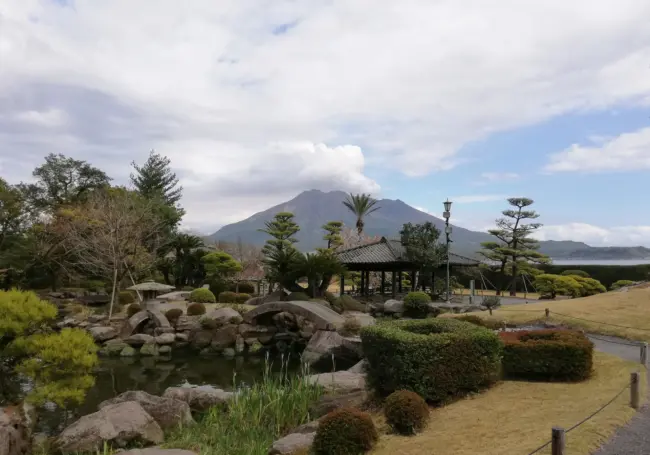 Traditional Japanese garden with koi ponds and Sakurajima in the background at Sengan-en in Kagoshima