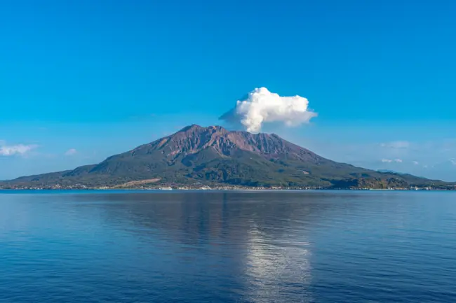 The smoking crater of Sakurajima volcano with a view of Kagoshima Bay