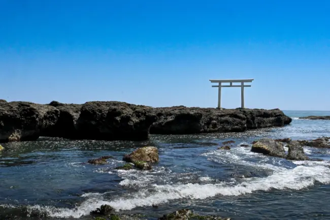 Oarai Isosaki Shrine’s torii gate, dramatically set in the waves of the Pacific Ocean.