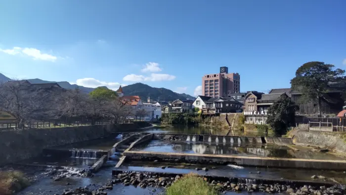 A tranquil outdoor hot spring bath surrounded by nature in Ureshino Onsen, Saga.