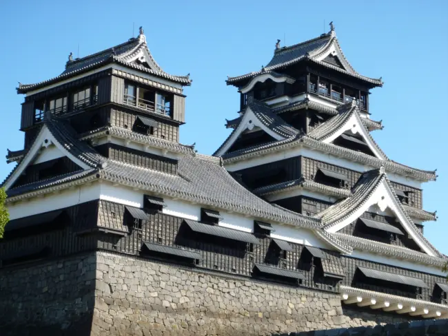 The impressive Kumamoto Castle with its massive stone walls and elegant architecture in Kumamoto City.