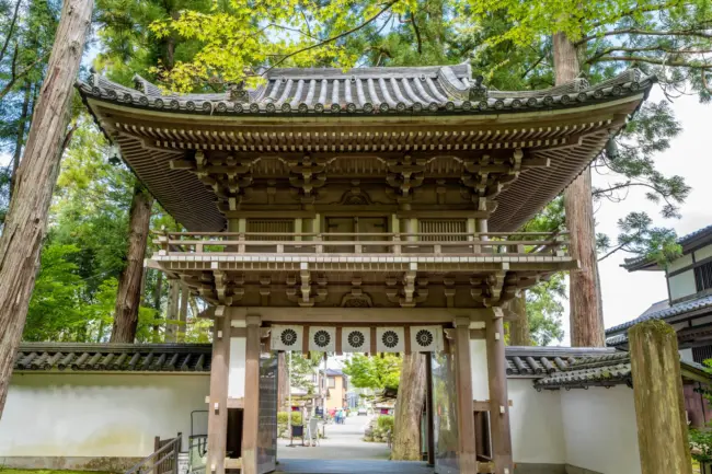 The dramatic cliffs and lush greenery surrounding Natadera Temple in Komatsu.