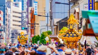 A traditional mikoshi (portable shrine) being carried through the streets during an autumn festival in Japan.