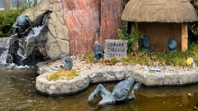 Bronze yokai statues lining Mizuki Shigeru Road, celebrating GeGeGe no Kitaro in Sakaiminato