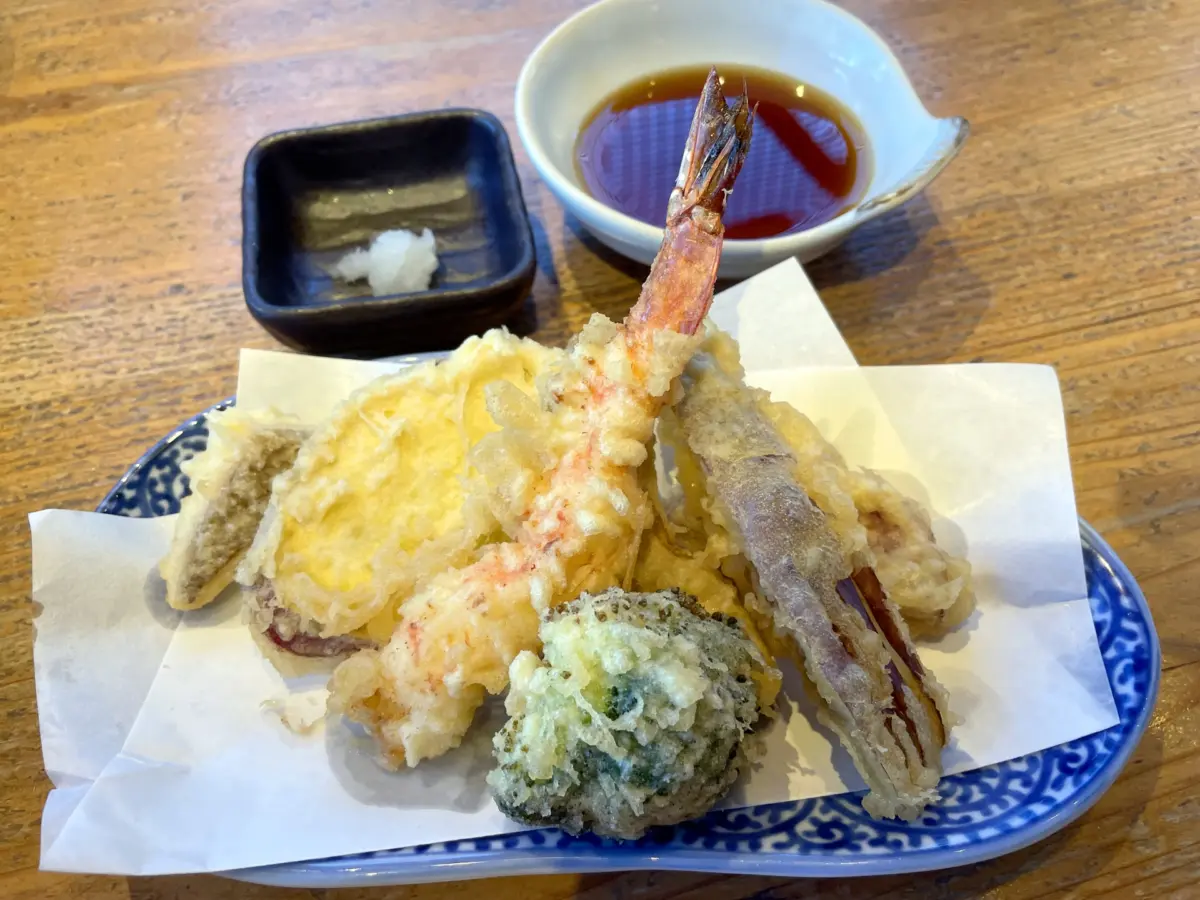 Crispy tempura served with a side of dipping sauce.