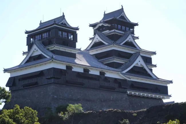 The impressive Kumamoto Castle with its massive stone walls and elegant architecture in Kumamoto City.