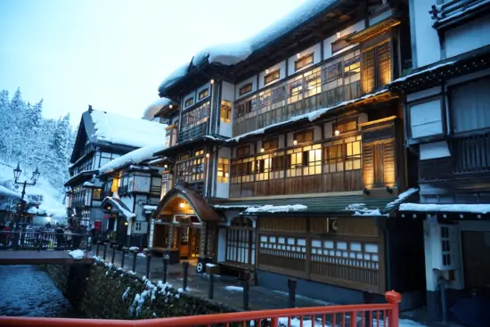 Ginzan Onsen’s historic streets and charming ryokan illuminated at night.
