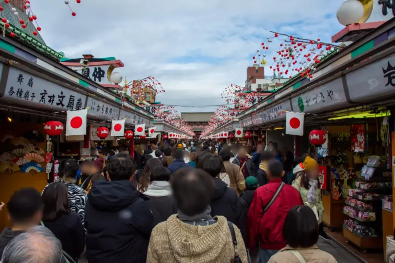 Bustling Nakamise Street, lined with shops selling traditional snacks and souvenirs.