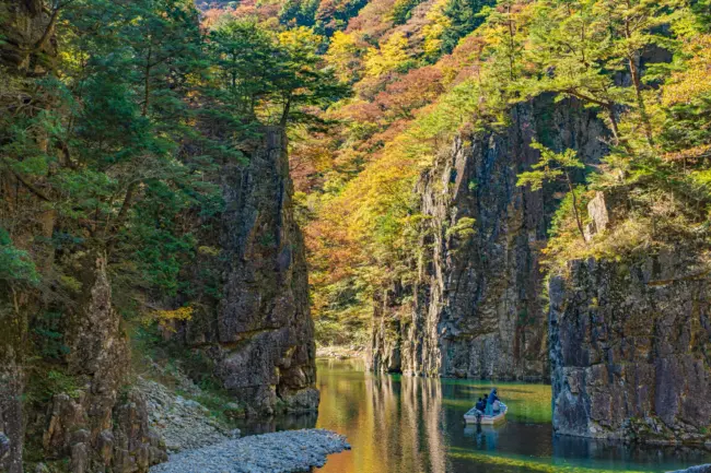 A dramatic waterfall surrounded by lush greenery in Sandankyo Gorge, Hiroshima