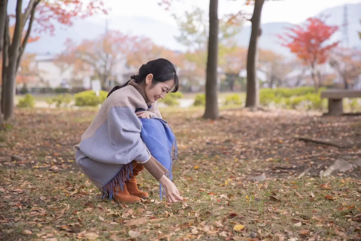 Woman wearing autumn attire, enjoying the changing leaves and the arrival of fall in Japan.