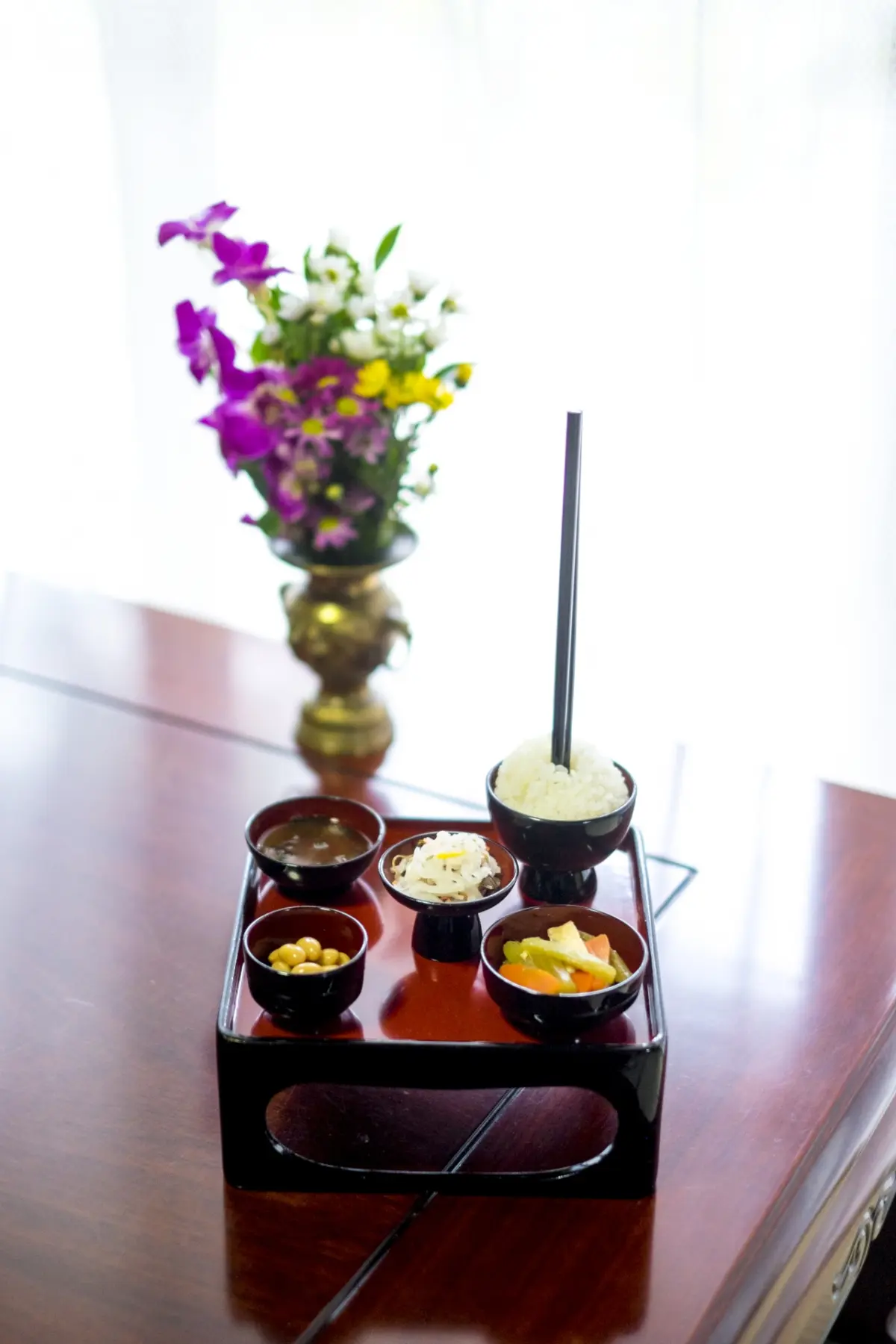 Rice offered in a bowl as an offering at a Buddhist altar, symbolizing respect and remembrance.