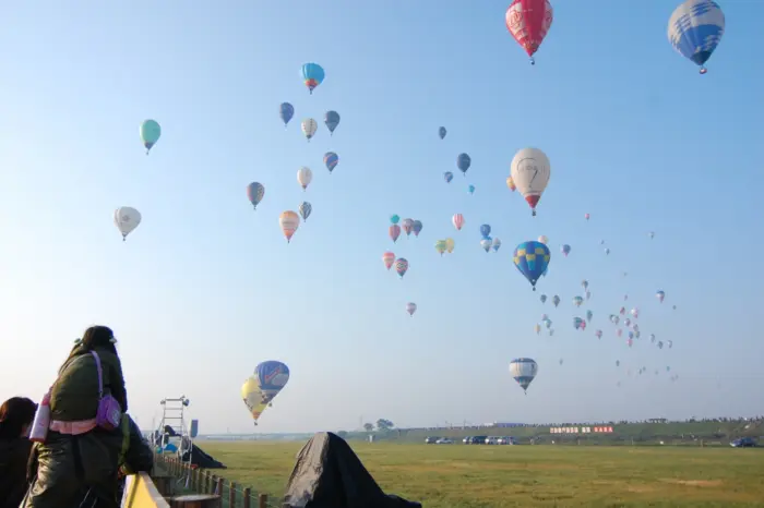 Colorful hot air balloons soaring over the countryside during the Saga International Balloon Fiesta.