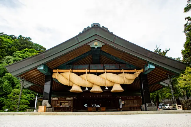 The grand main hall of Izumo Taisha Shrine surrounded by sacred pine trees in Shimane