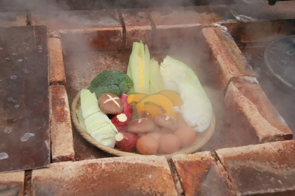 Steam-cooked dishes, including eggs and pudding, served at Kannawa Onsen.