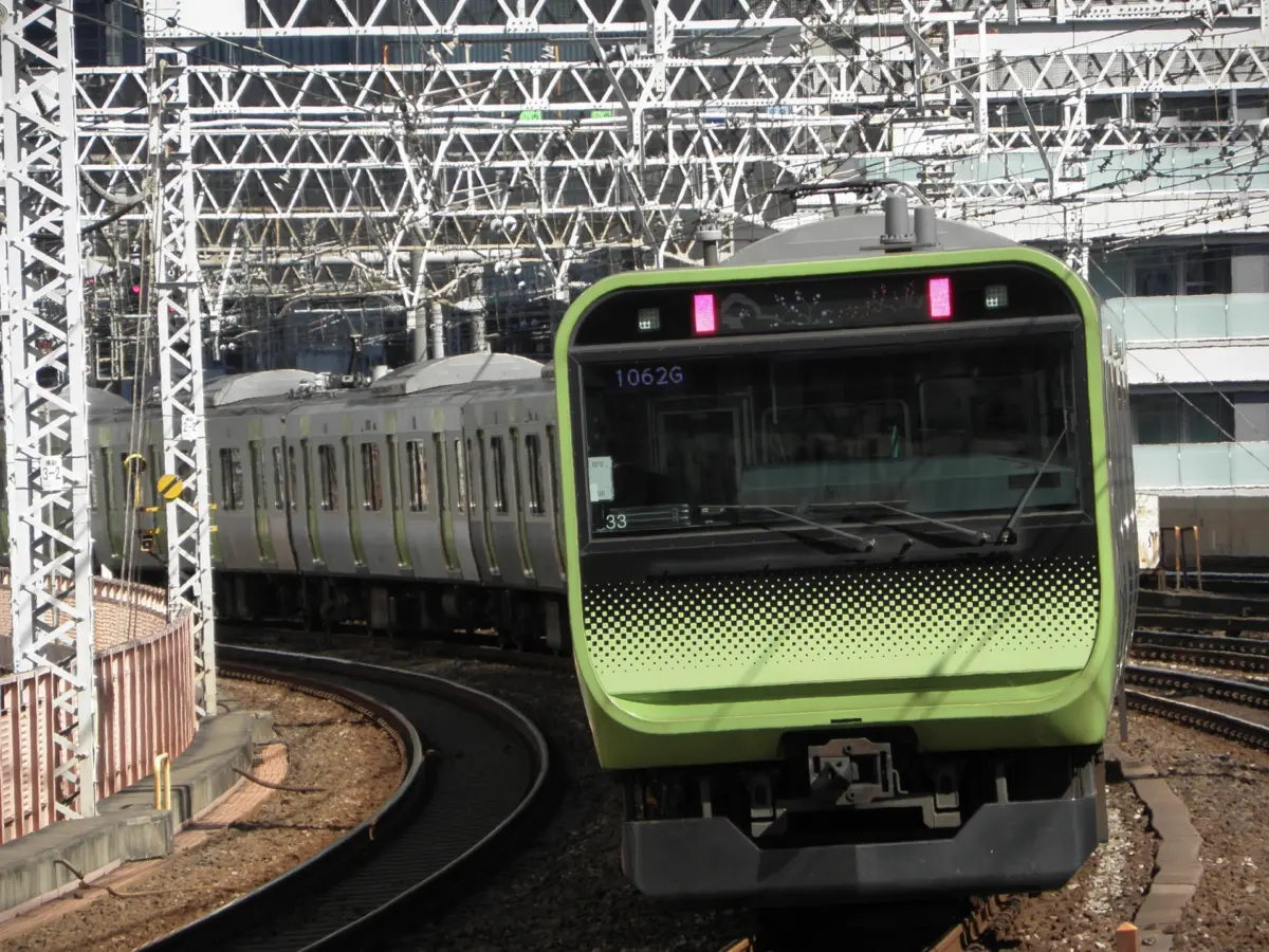 Green train of the Yamanote Line passing through Tokyo.