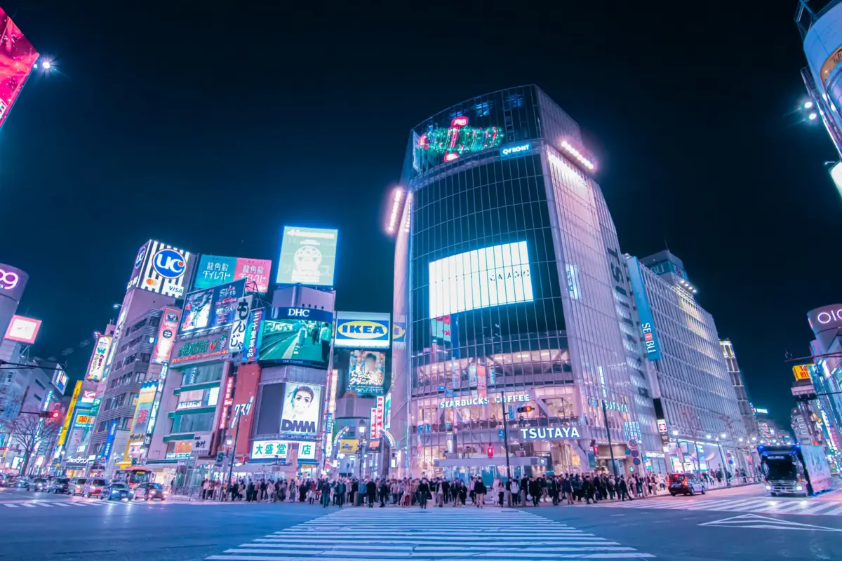 Night view of the Scramble Crossing next to the Hachiko statue in Shibuya, Japan.