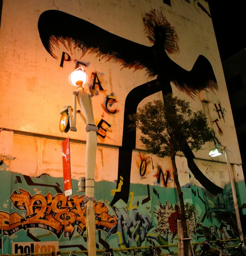 A colorful mural in Amerikamura Osaka, featuring vibrant street art by local artists.