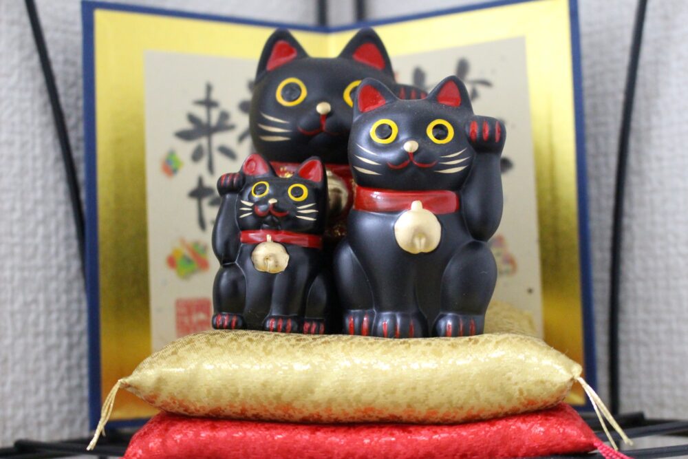 A collection of colorful Maneki Neko statues