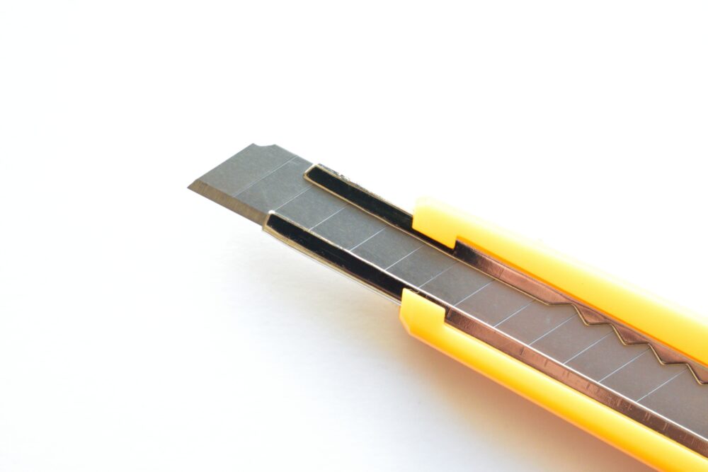 A yellow utility knife with a snap-off blade.
